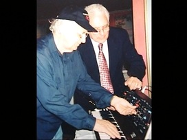 Gershon Kingsley and Bob Moog with the mini Moog.